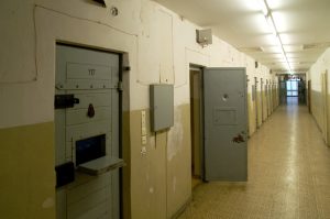 Hallway with an open cell in an abandoned prison in the eastern part of Berlin